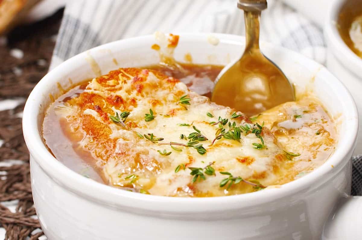 bowl of french onion soup with bread and melty cheese