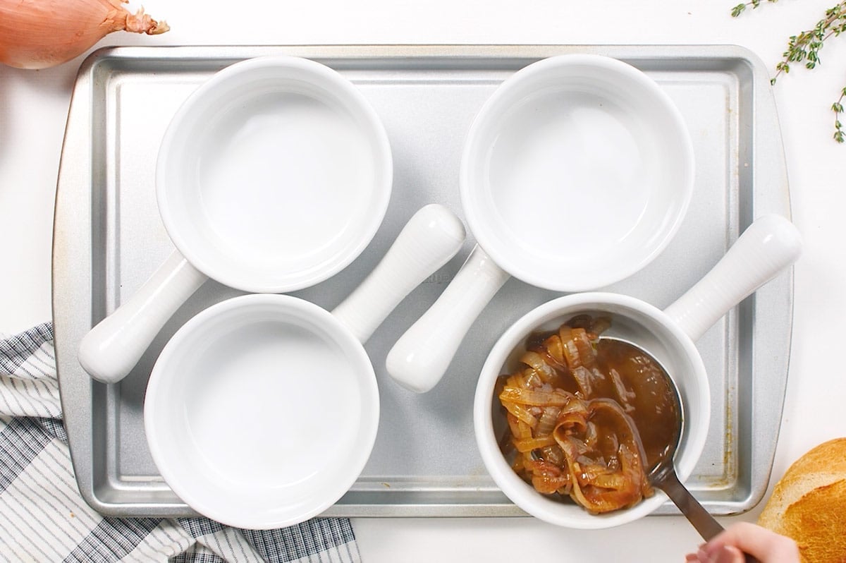 french onion soup ladled into soup crocks