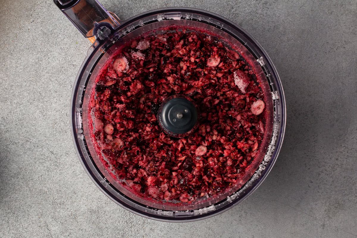 mulched fresh cranberries in bowl of food processor