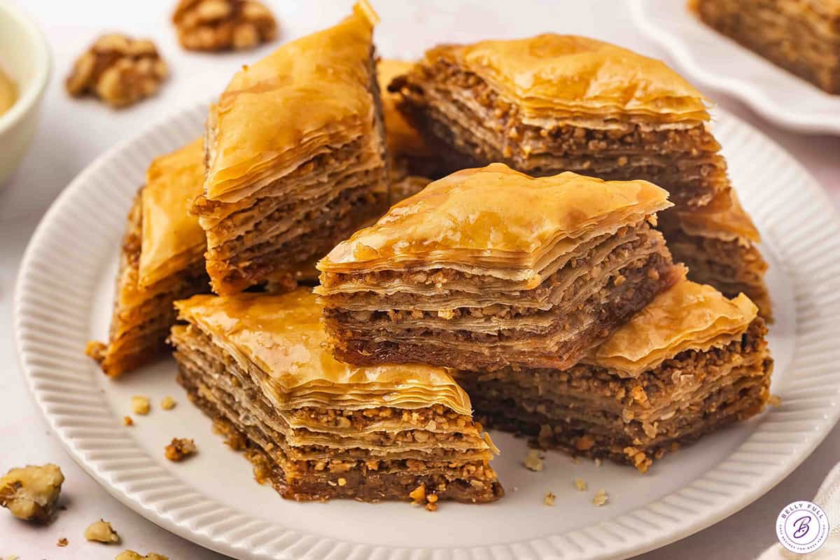 Baklava pieces stacked on serving plate