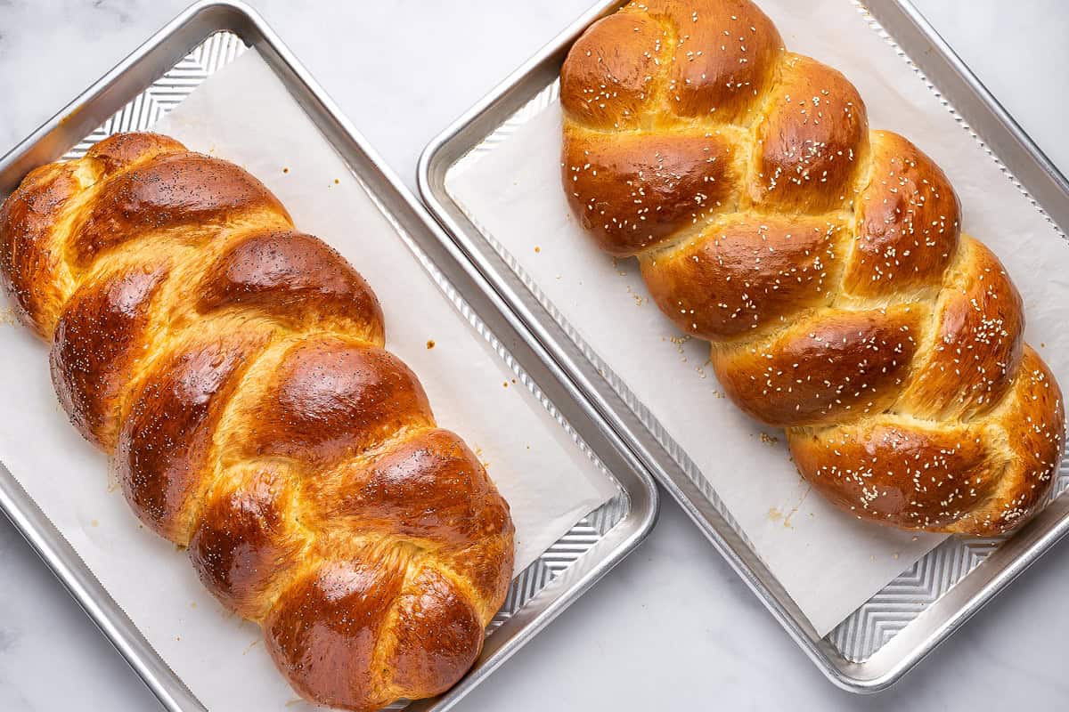 2 loaves of baked challah bread on baking sheets