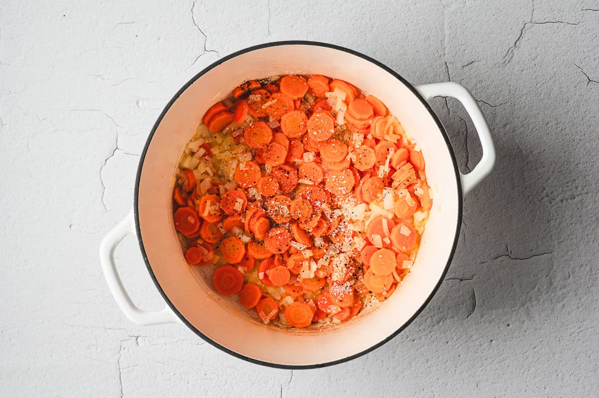 carrots, onions, and seasonings in soup pot