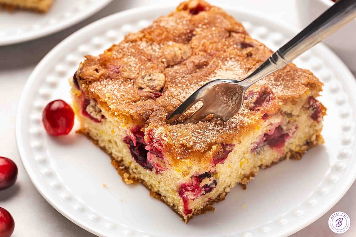 slice of Cranberry Christmas Cake on plate with fork