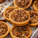 Mini Pecan Pies stacked on serving tray
