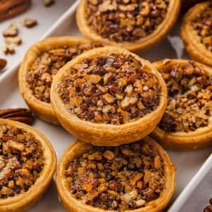 Mini Pecan Pies stacked on serving tray