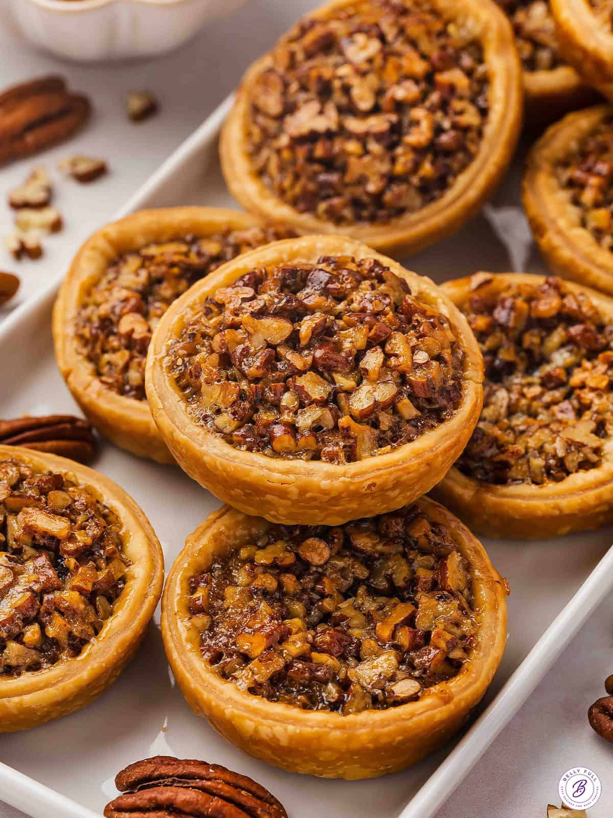 Mini Pecan Pies stacked on serving tray