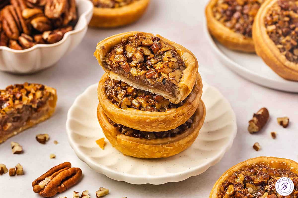 3 stacked mini pecan pies, top one sliced in half