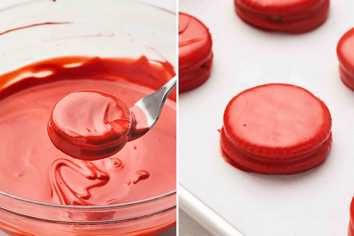 Ritz peanut butter sandwich being dipped into melted red candy coating and placed on a parchment-lined sheet to set.