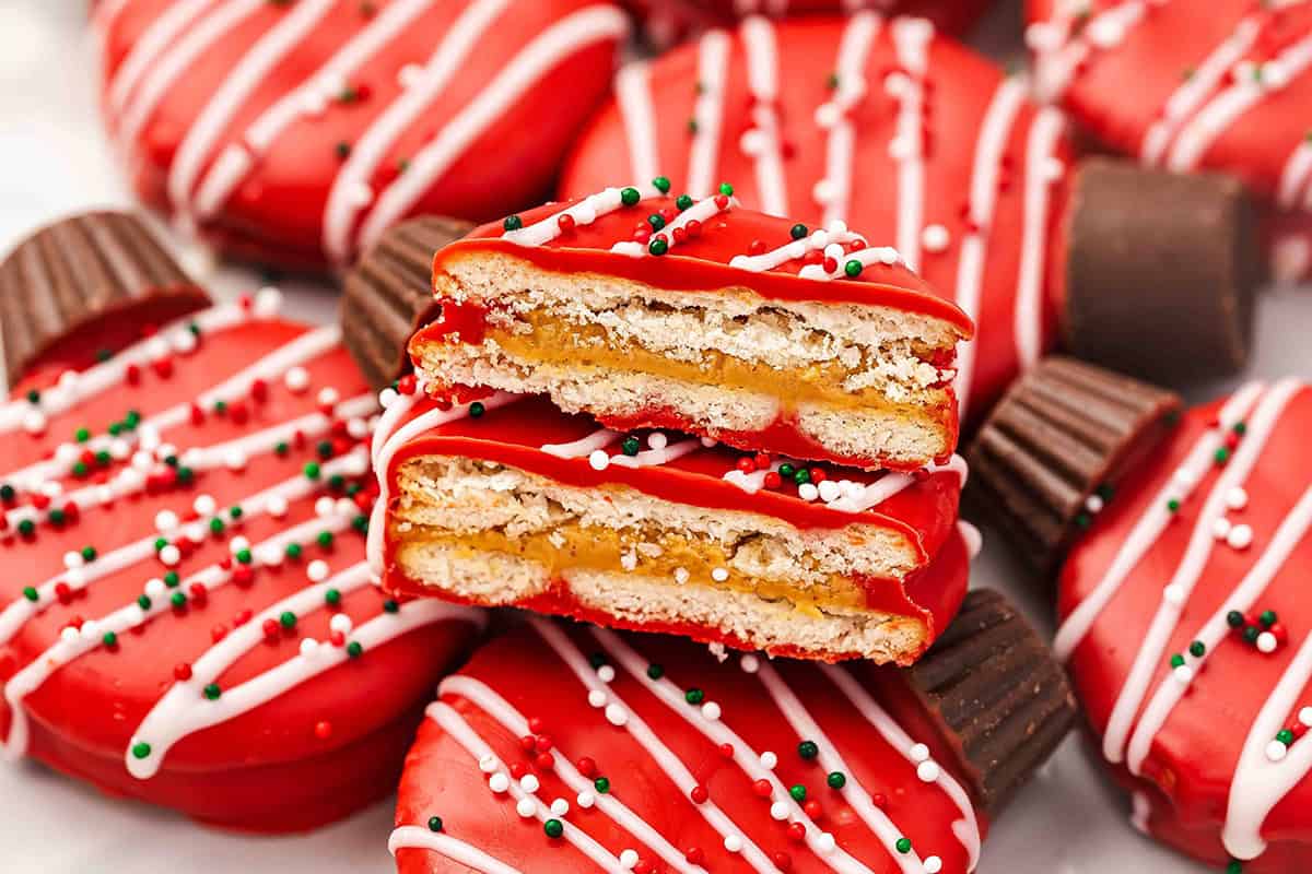 Cross-section of a chocolate-covered Ritz ornament cookie showing the peanut butter filling between two crackers.
