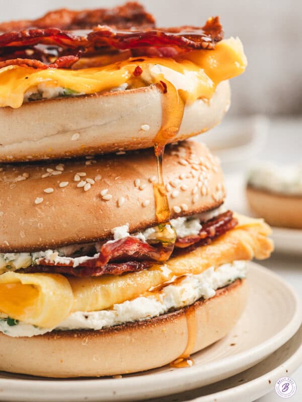 Bee sting bagel stacked with bacon, creamy eggs, jalapeño cream cheese, and melted cheese, drizzled with hot honey