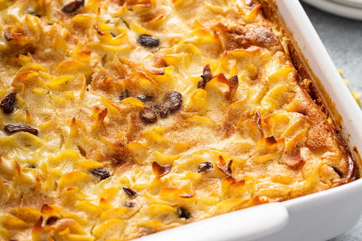 close up baked noodle kugel in baking dish
