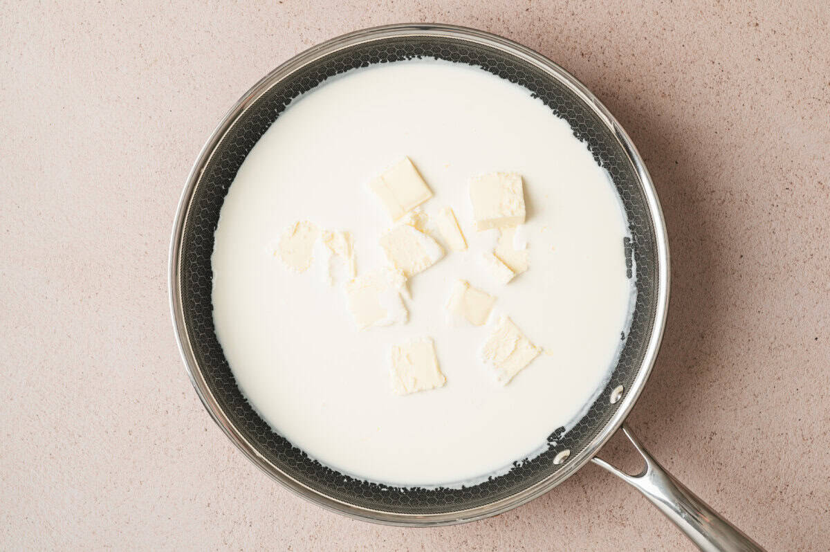heavy cream and sliced butter in sauce pan