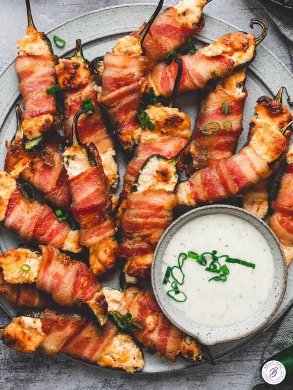 overhead Bacon Wrapped Jalapeno Poppers on serving tray with ranch dressing for dipping