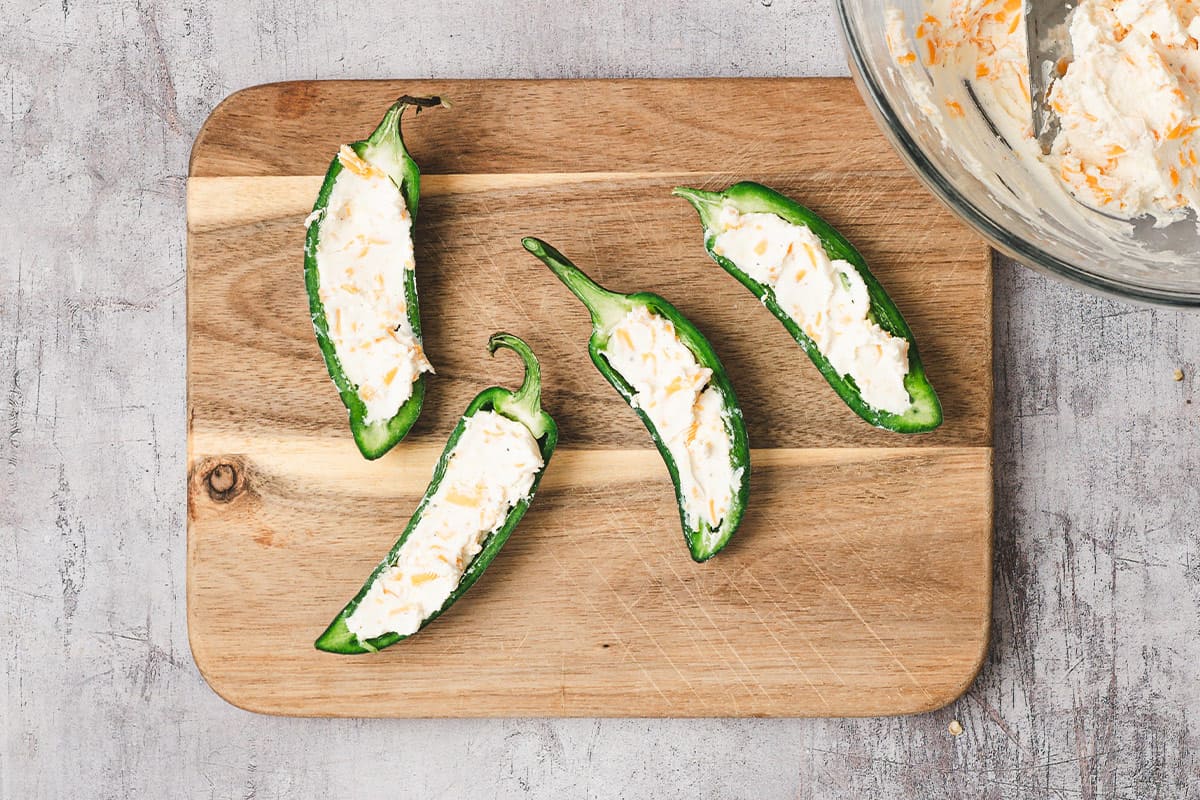 halved jalapeno peppers stuffed with cream cheese mixture
