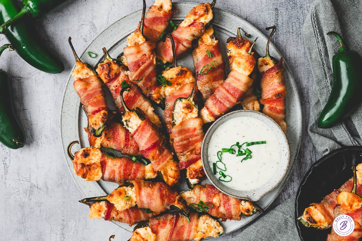 overhead Bacon Wrapped Jalapeno Poppers on serving tray with ranch dressing for dipping