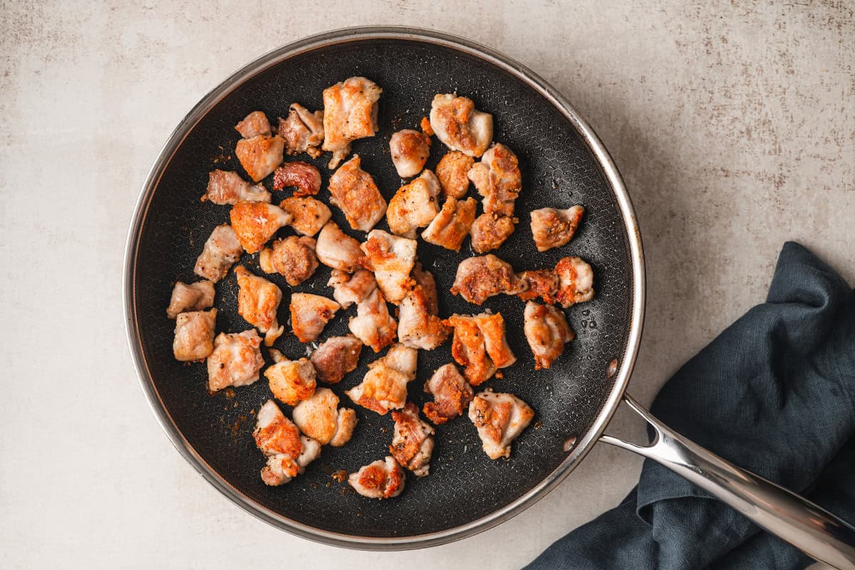 browned chicken thigh pieces in skillet