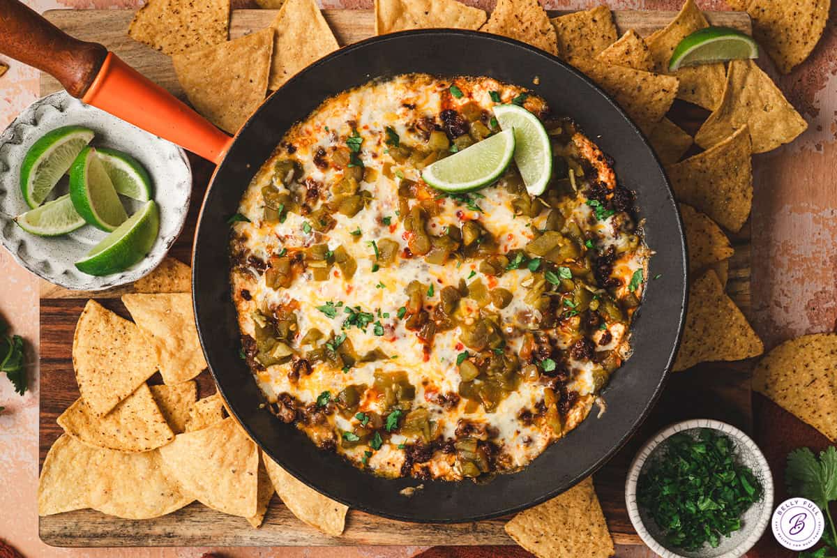 finished chile relleno dip in skillet garnished with lime