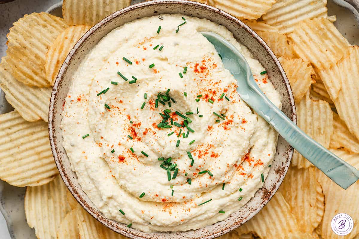 overhead view of deviled egg dip with chips in a serving dish