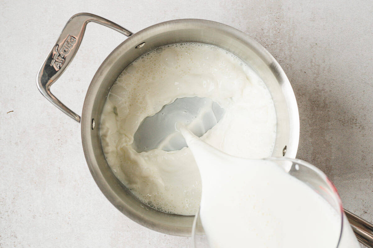 whole milk being poured into pot