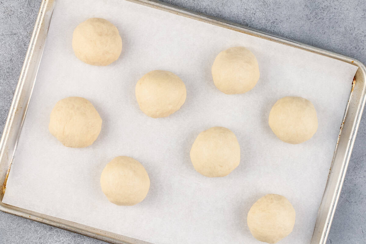 stuffed dough balls on baking sheet