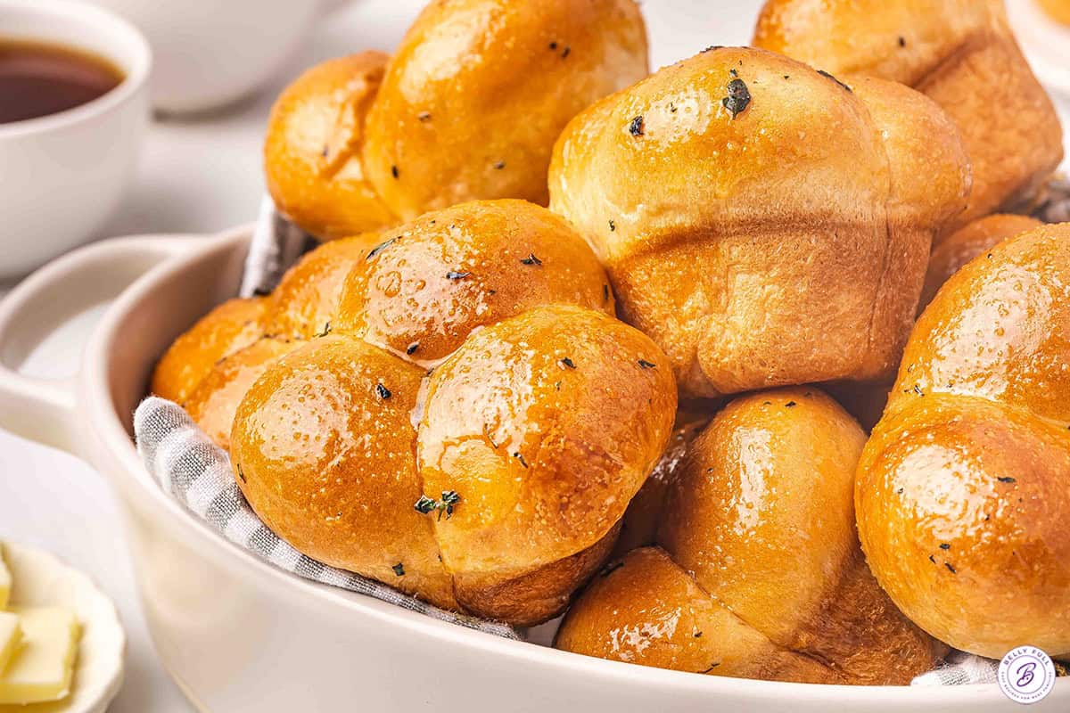 Homemade cloverleaf rolls on a plate.