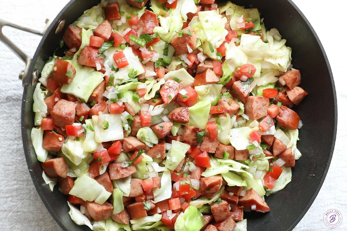 Cabbage, diced kielbasa, and pice de gallo mixed together in skillet