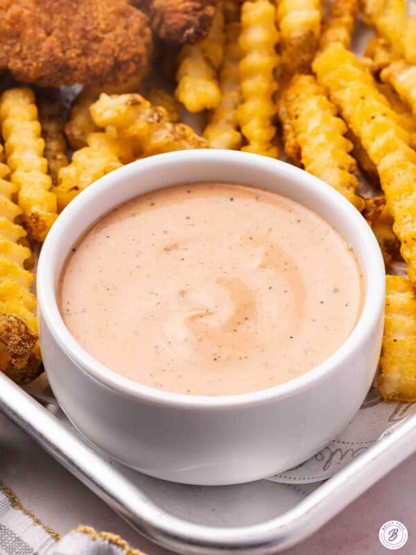 Side view of a bowl of raising cane's sauce.