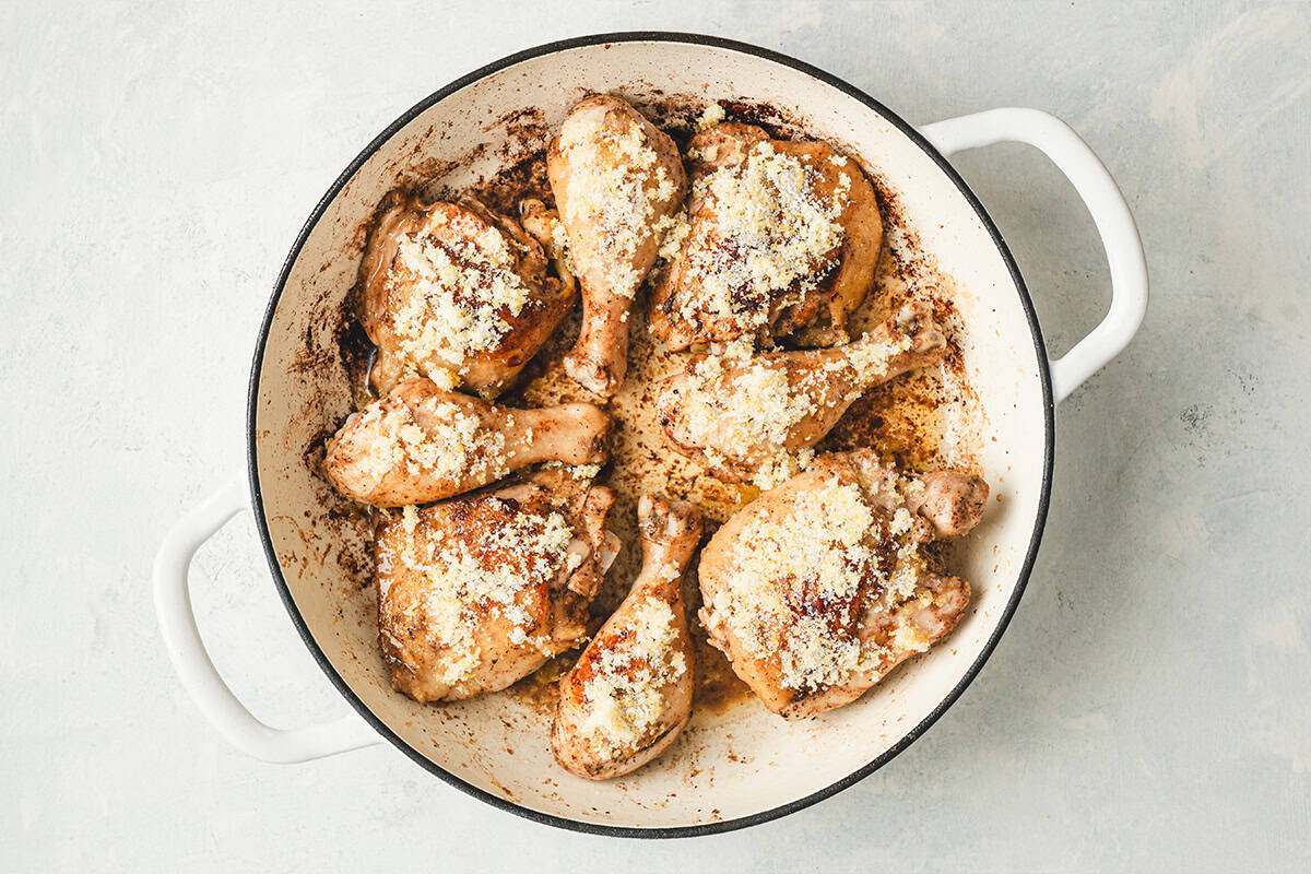 Chicken pieces in skillet sprinkled with lemon sugar before roasting in the oven