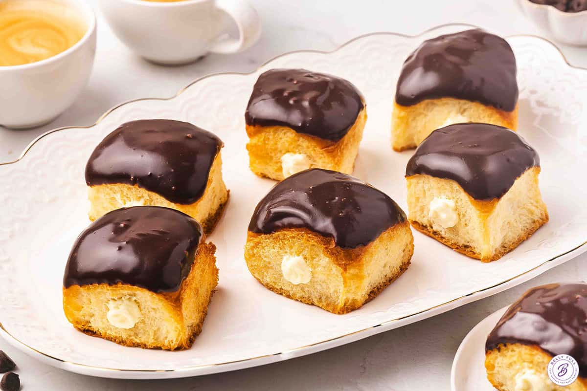 Side view of Boston cream roll pie 'donuts' on a platter.