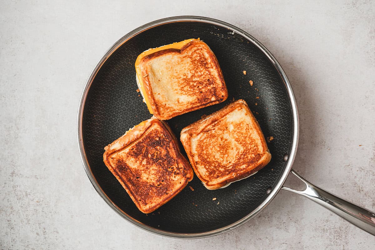 Three Disneyland copycat grilled cheese sandwiches on a plate.
