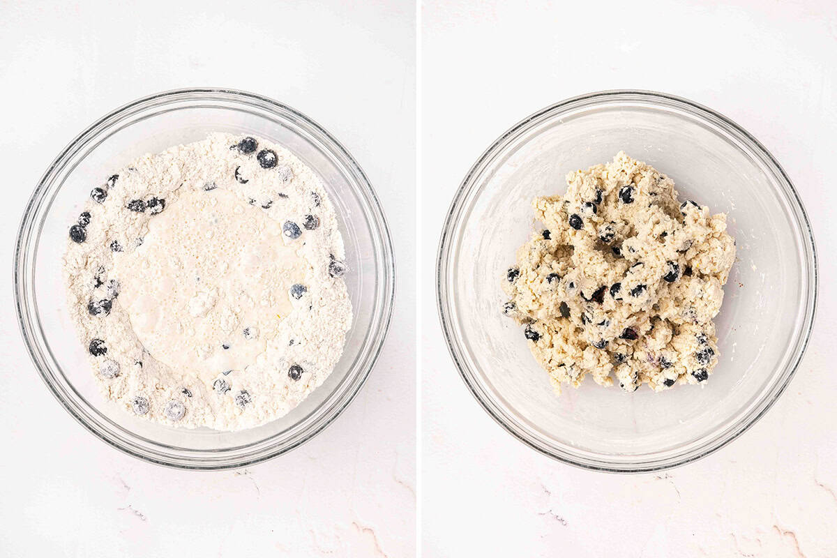 Blueberries and half and half added to the flour mixture, then mixed into shaggy lemon blueberry scone dough in the bowl.