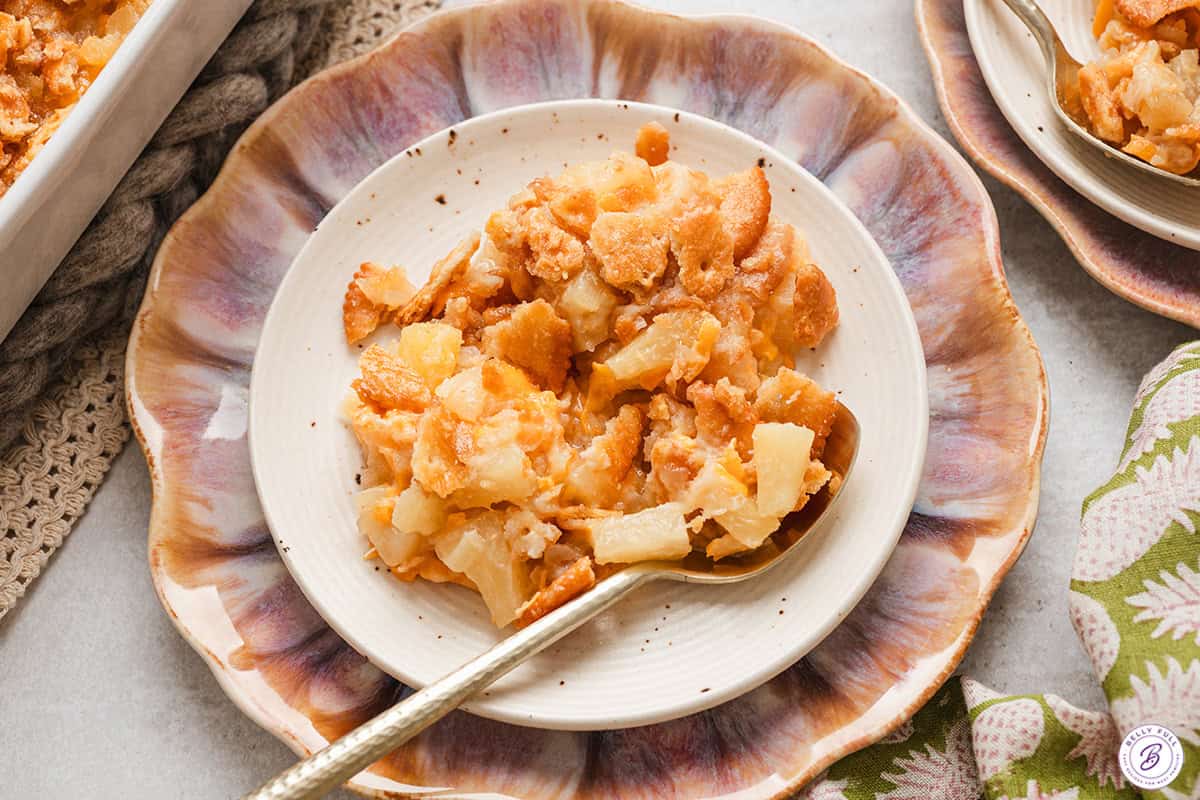 Pineapple casserole on a plate with a spoon.