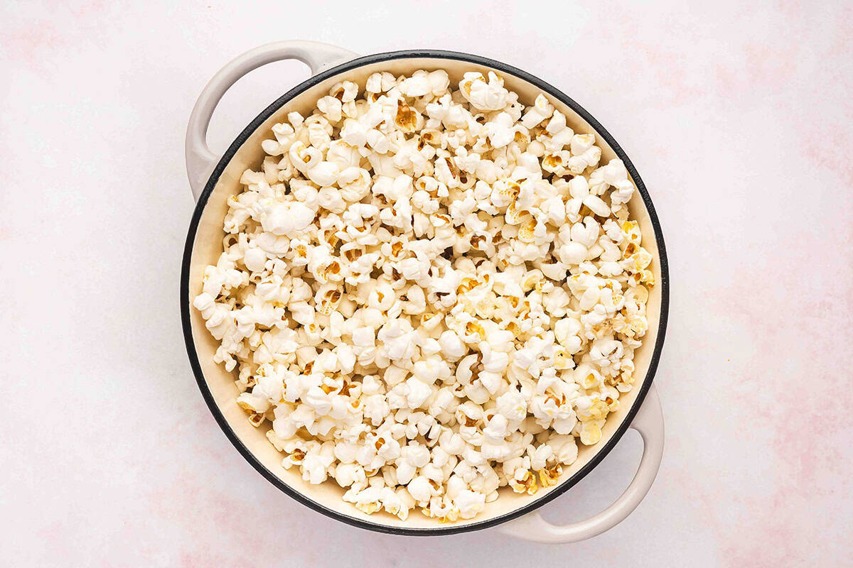 Freshly popped stovetop popcorn filling a large pot.