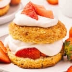 Side view of a strawberry shortcake on a plate.