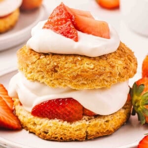 Side view of a strawberry shortcake on a plate.
