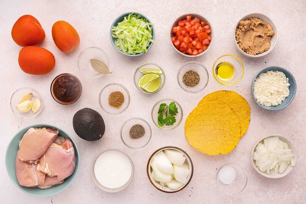 The ingredients to make chicken tinga tostadas.