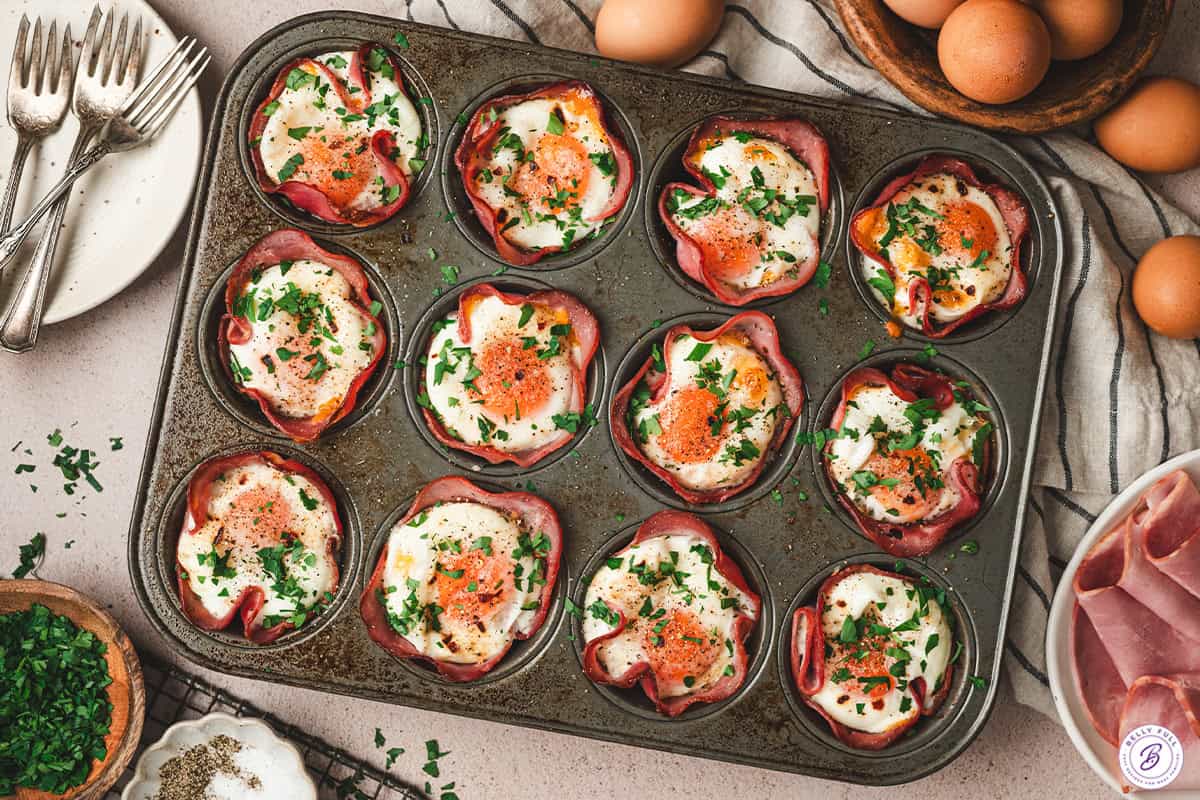 Overhead view of a pan of homemade ham and cheese egg cups.