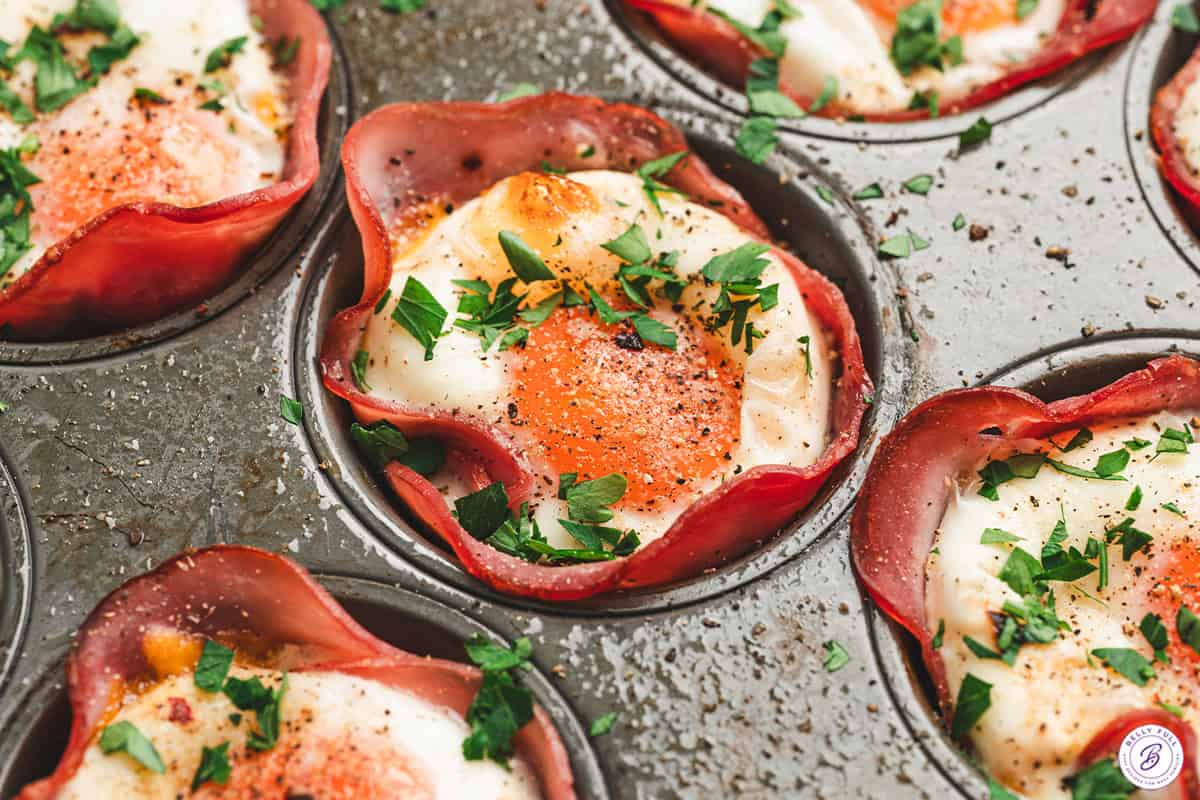A close up of a ham and cheese egg cup.