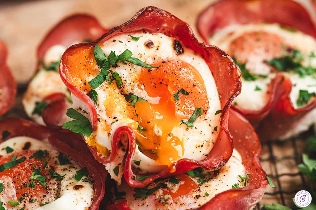 A close up of a ham and cheese egg cup.
