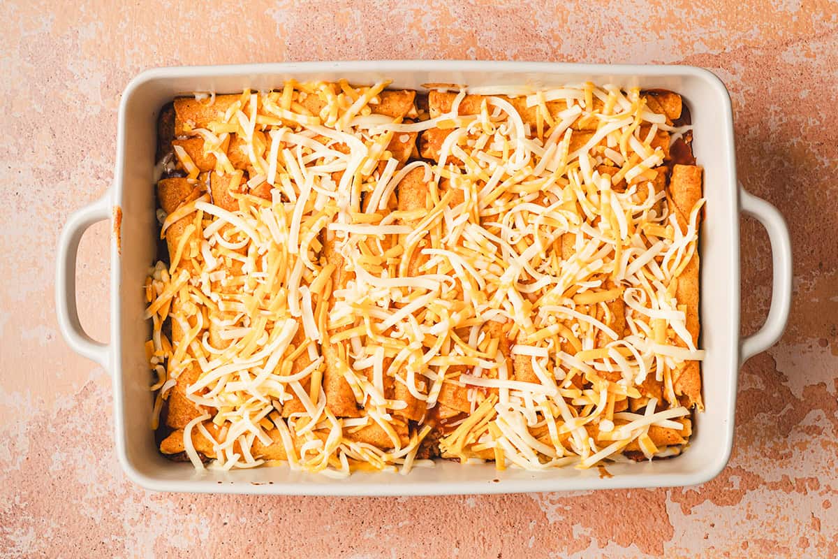 A baking dish of lazy enchiladas topped with cheese.
