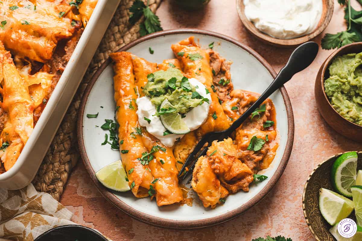 Lazy enchiladas on a plate with sour cream and guacmole.