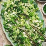 Overhead view of maroulosalata salad on a platter.