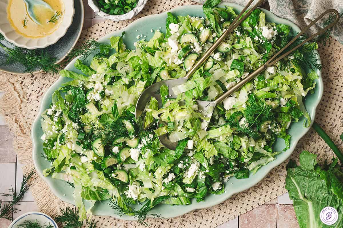 Overhead view of maroulosalata salad on a platter.