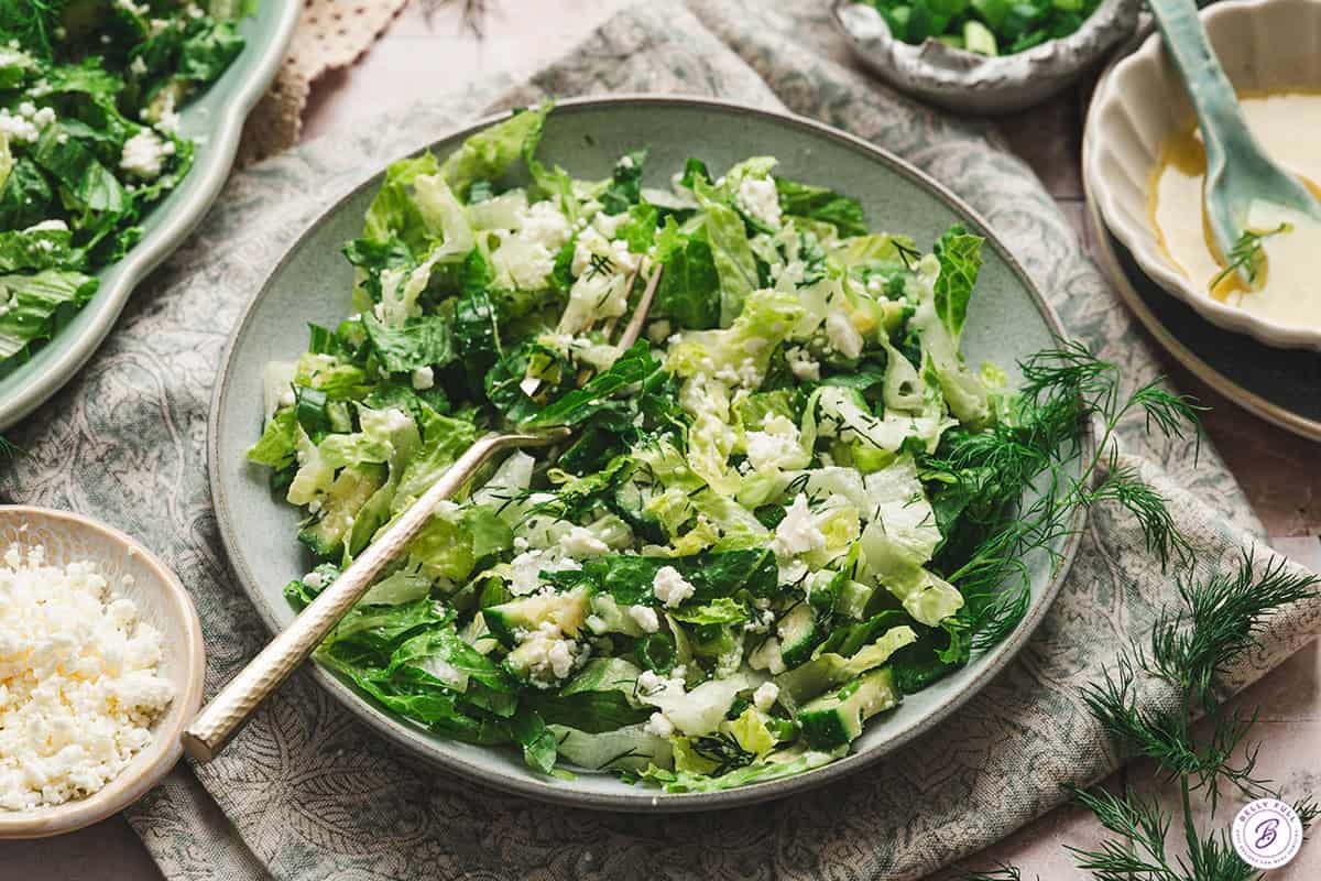 A bowl of maroulosalata with a fork.