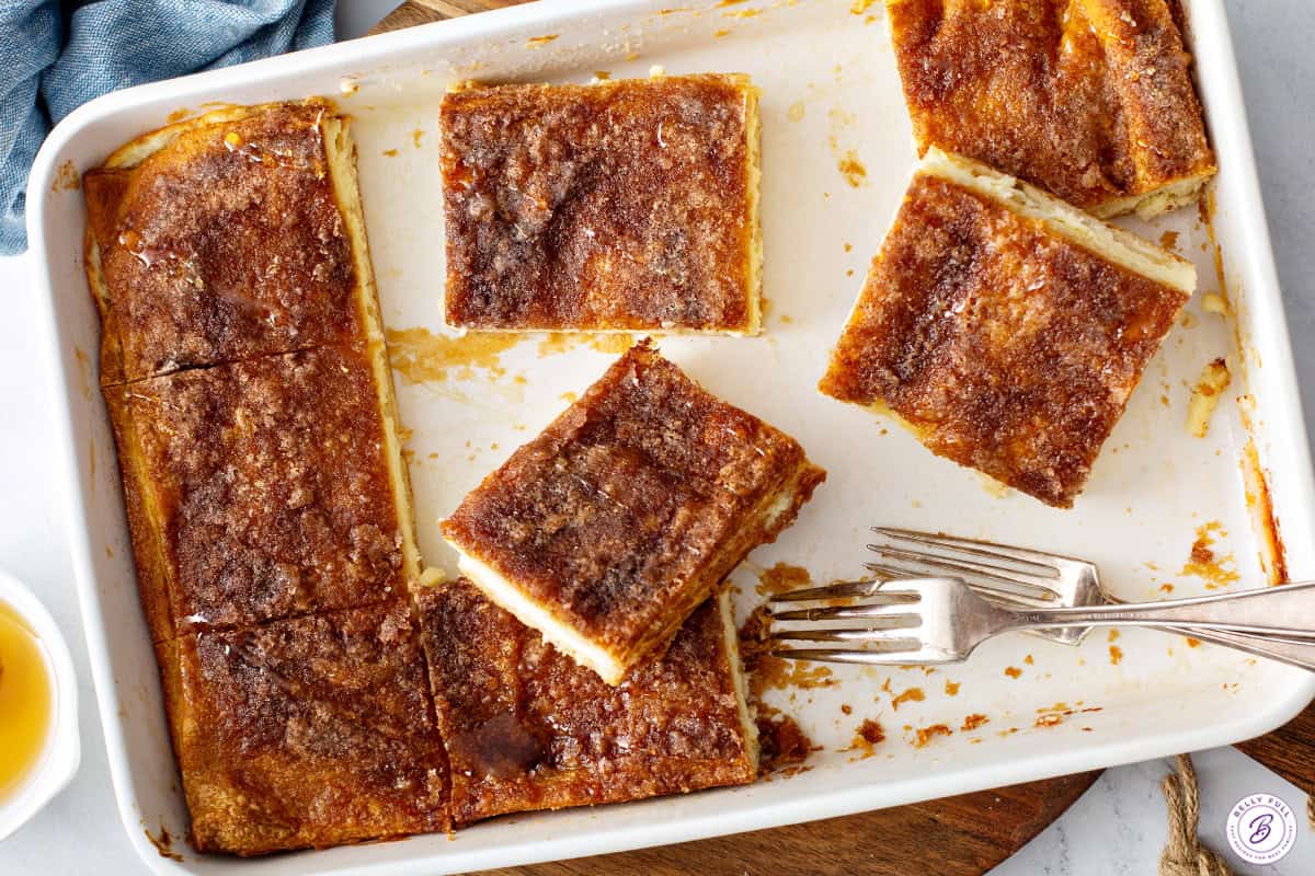 baked dish of Sopapilla Cheesecake cut into