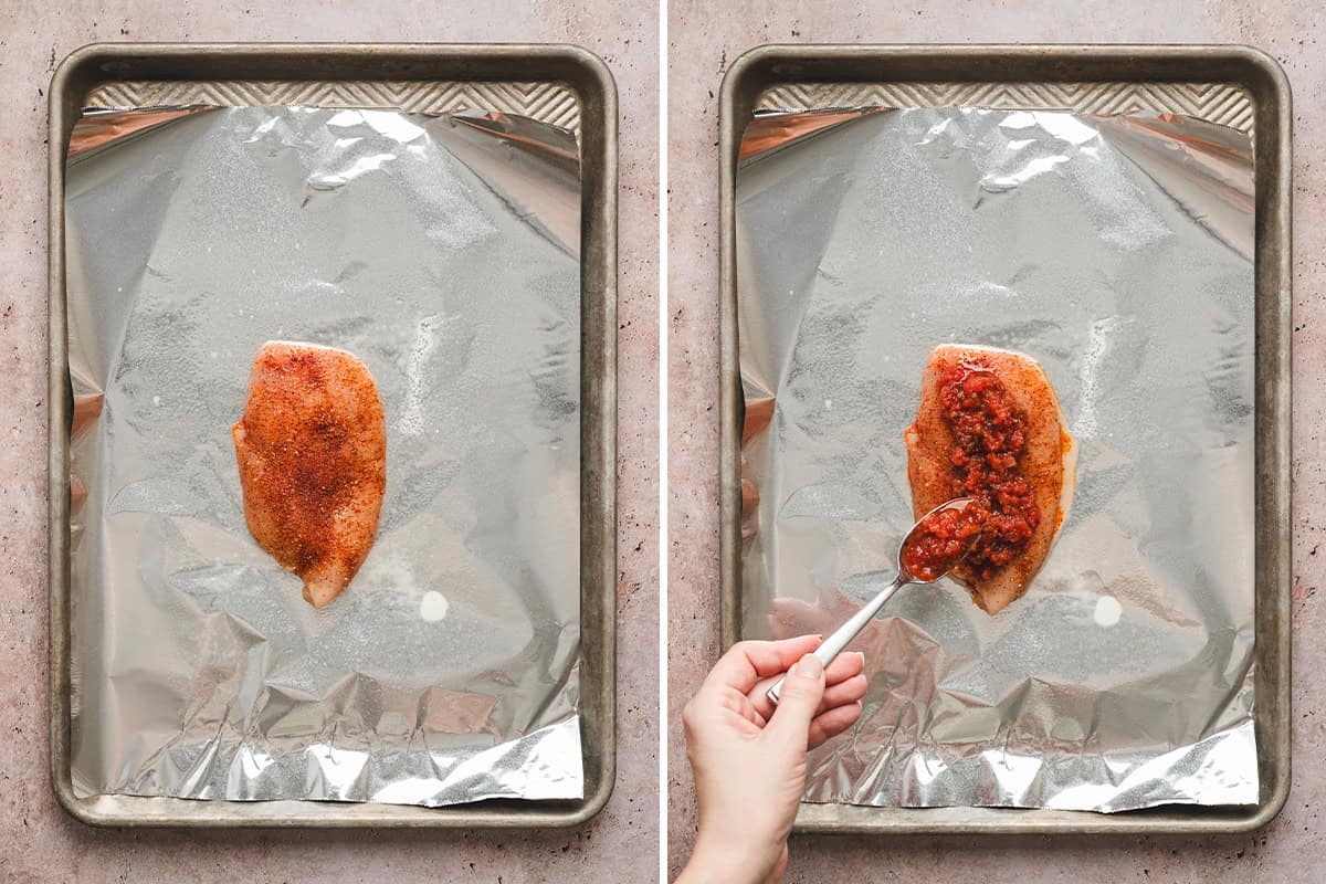 A seasoned chicken breast on a foil sheet being topped with salsa.