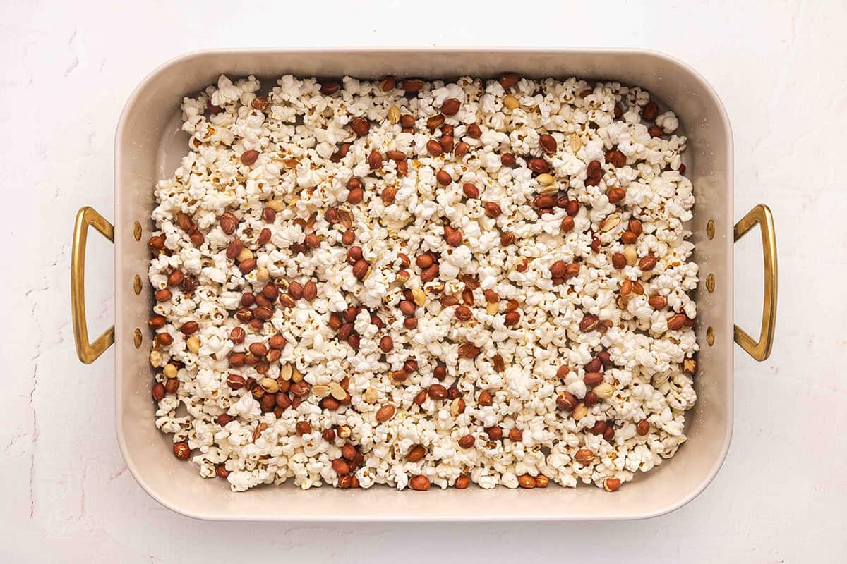 Popcorn and roasted peanuts on a baking sheet.