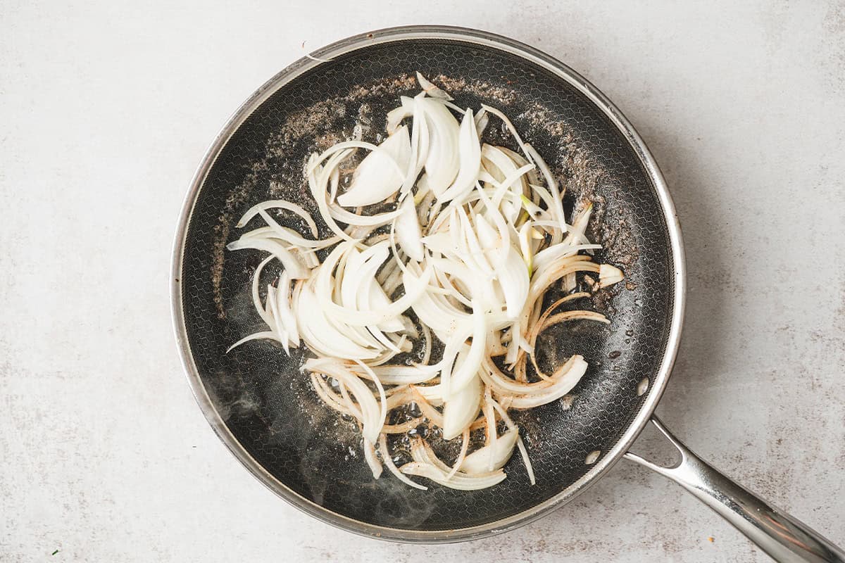 Sliced onions in a skillet.