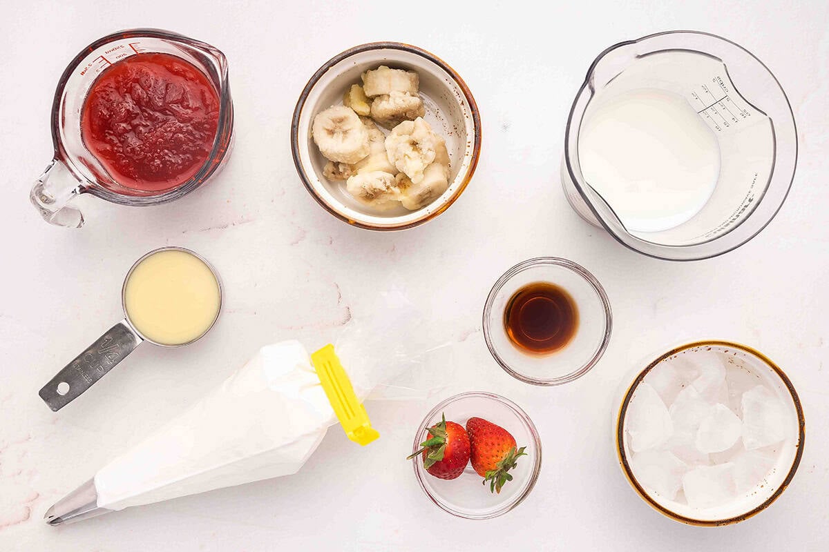 The ingredients to make a Strawberry Banana Orange Julius drink.