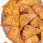 Overhead view of air fryer wonton chips on a plate.